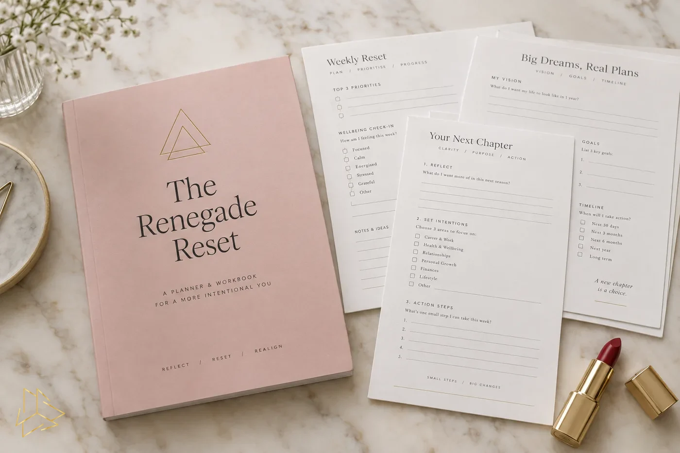 The Renegade Reset planner cover in blush pink beside sample worksheet pages and a red lipstick